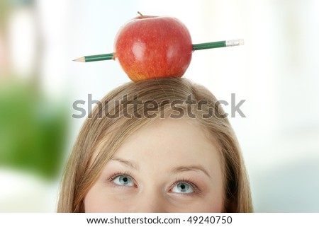 Beautiful student woman have one apple with pencil on her head - learning concept