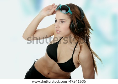 Listening to the Music, young caucasian beautiful woman with headphones, against blue graffiti