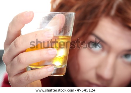 Alone young woman in depression, drinking alcohol (bourbon)