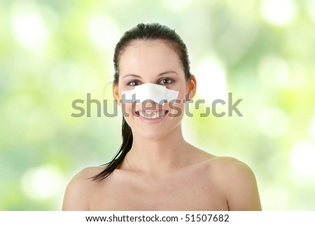 Young beautiful woman face after nose surgery