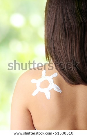 Young woman with sun-shaped sun cream