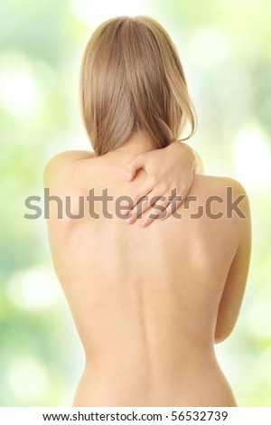 Woman from behind, naked body, pain concept,against abstract green background