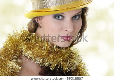 Young beautiful caucasian woman in black elegant party dress and gold hat