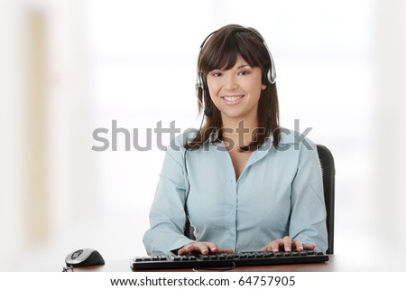 Young beautiful customer service operator girl in headset ,sitting at the desk