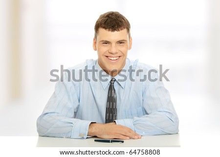 Young businessman behind the desk