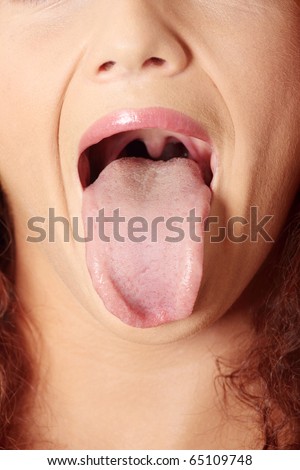 Portrait of beautiful woman who puts tongue out