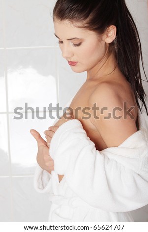 stock photo Young caucasian adult woman examining her breast for lumps or