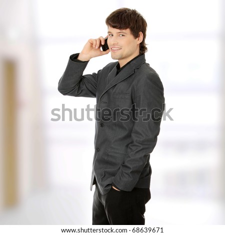 A handsome happy business man using mobile phone