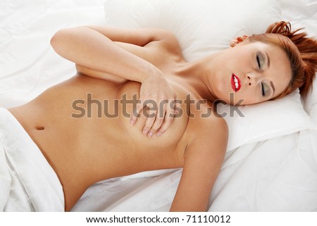 Pretty sexy topless woman on the bed.