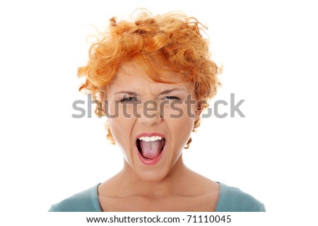 stock photo Furiouse young redhead woman screaming Isolated on white