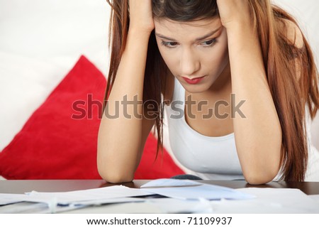 A young beautiful woman stressed because of bills.
