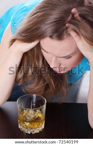 Young corpulent woman in depression, drinking alcohol