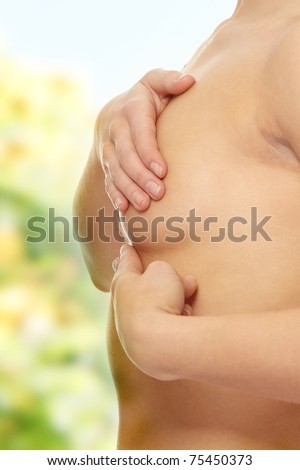 Breast cancer check- Woman holding her breast