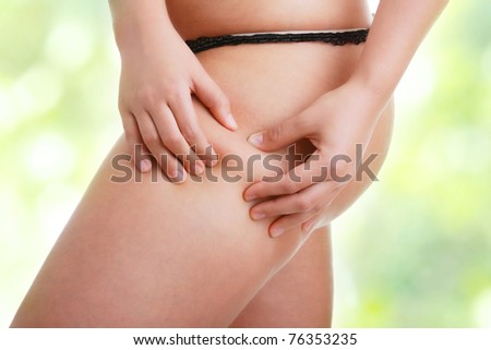 Woman pinching leg for skin fold test
