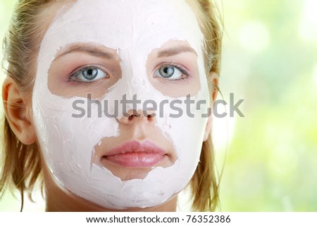 Cosmetics mask of clay on the  young female face