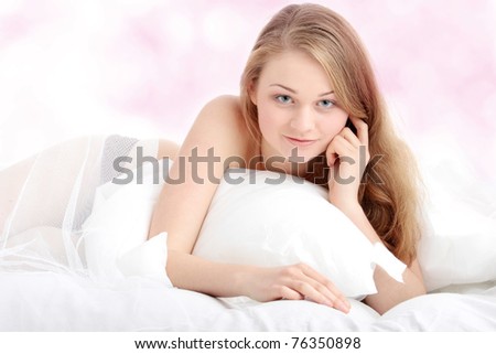 Portrait of pretty sexy blond woman on the bed.