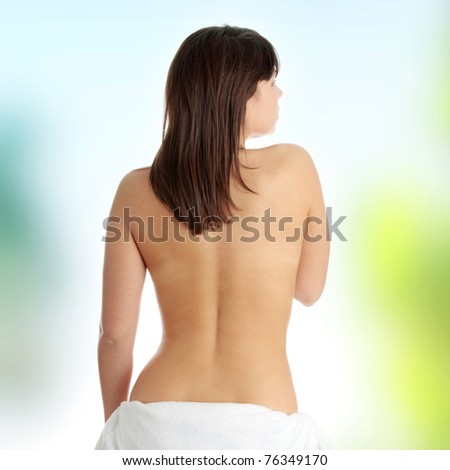 Young beautiful woman topless, in towel, view from back