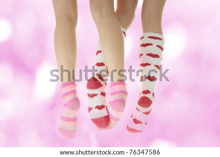 Four crossed legs with colorful socks - friendship or love concept