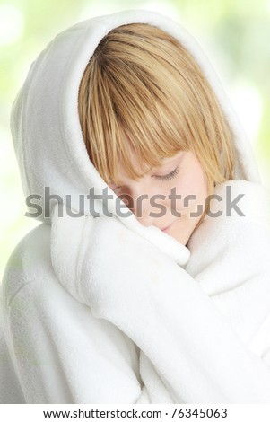 Beautiful young caucasian woman in bathrobe after bath calm portrait,  on abstract green background
