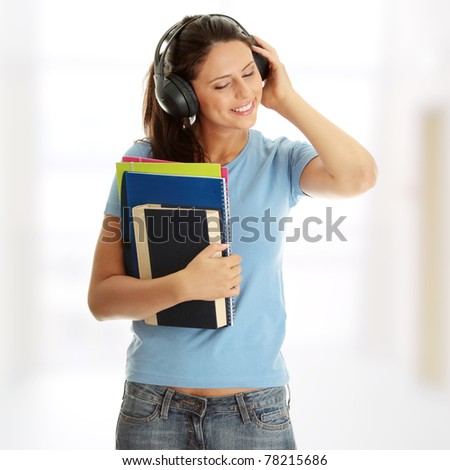 Happy student girl listening to the music