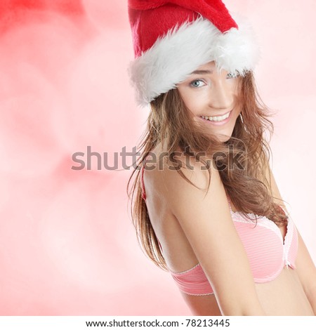 Beautiful,slim, fit and sexy Caucasian woman in pink underwear and santa hat