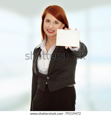 Beautiful smiling business woman holding a blank card - focus on card