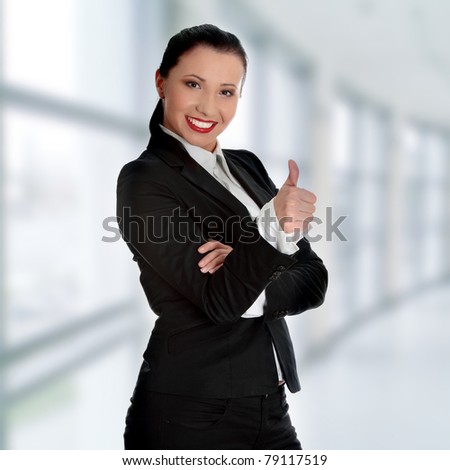 Confident business woman standing wearing elegant clothes with thumb up