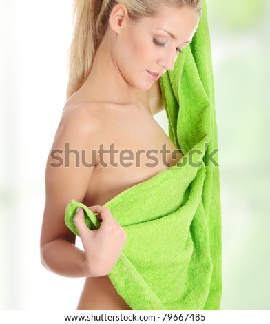 stock photo Young beautiful nude blond woman with towel