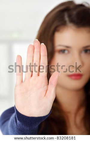 Hold on, Stop gesture showed by young teen woman hand. Isolated on white