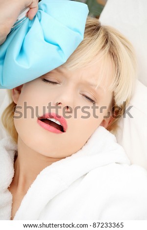 Sick woman at home with terrible headache