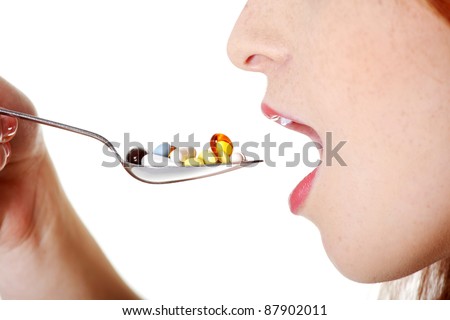 stock photo Closeup on teen caucasian girl s open mouth taking pills from 