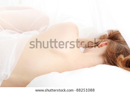 Portrait of pretty sexy blond woman on the bed.