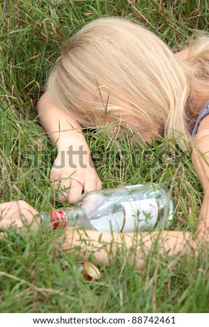 Teen alcohol addiction (drunk teen with vodka bottle)