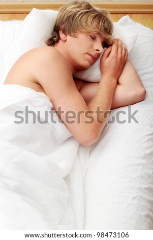 Man comfortably sleeping in his bed.