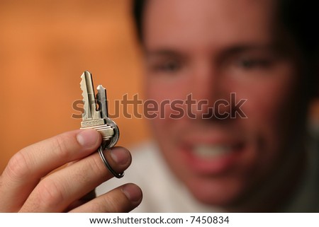 Key in hand with blurred face