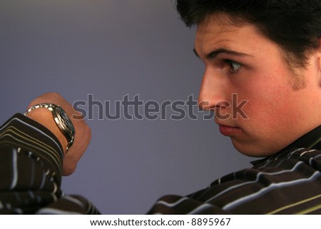 young man looking at watch