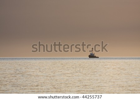 A single tug on its way in evening light