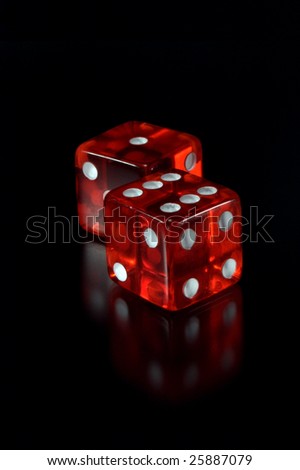 Two dices on a black background. Focus on a first dice.