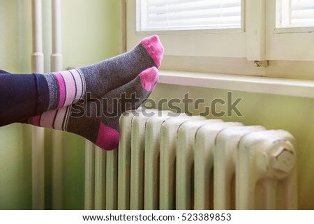 happy feet resting on the white, warm radiator