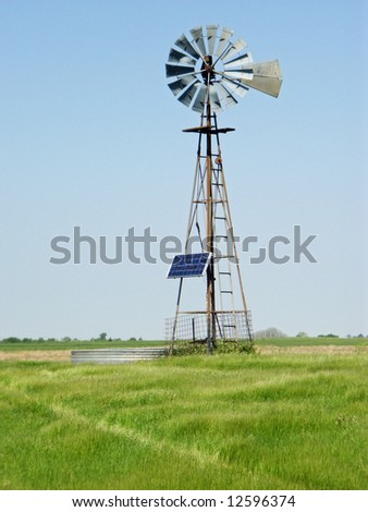 A rural windmill equipped with a solar power to store energy