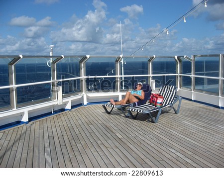 Middle-aged woman alone on the top deck of a cruise ship