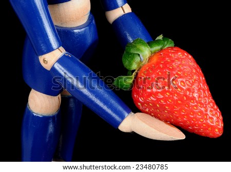 A wooden figure offers up a gift of fresh fruit