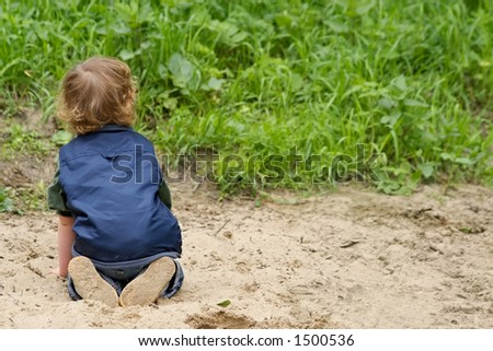 The boy plays sand on a beach