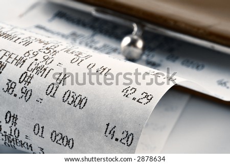 Cash receipt illustrating the spent money on background of a purse