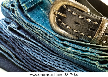 Vintage denim clothes-pile of jeans and leather belt