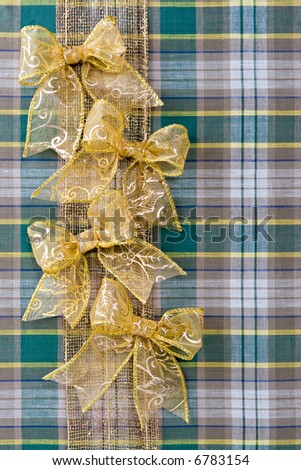 Holiday christmas packing from a fabric and gold bows