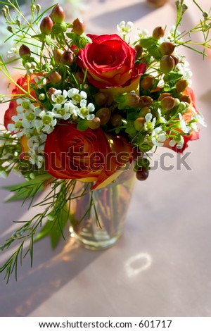 red roses and white baby\'s breath in jar