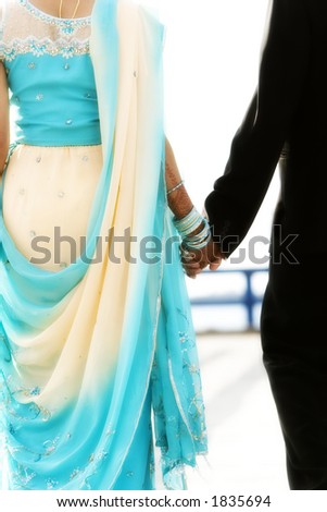 indian bride and groom walking away together