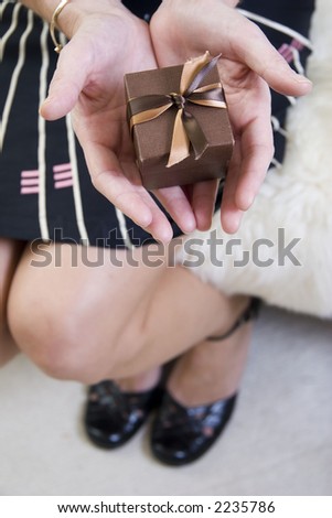 woman holding small gift in hands