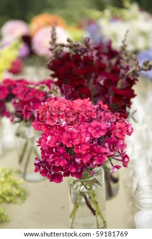 flowers in mason jars - country style - bright colors with blurs